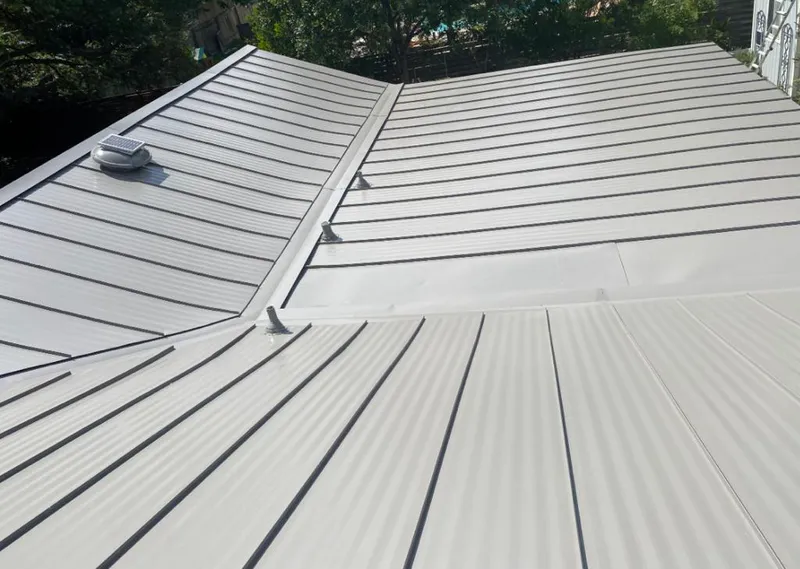 Solar attic fan installed on a metal roof for Roof Ventilation in Suffolk